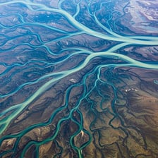 Aerial view of a river dividing into branching channels at its delta