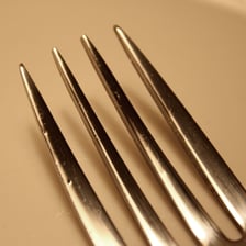 A close view of the pointed tines on a metal fork.