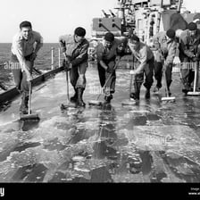 Sailors standing on the deck of a naval cruiser
