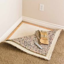 Small carpet fasteners used along the edge of a floor covering.