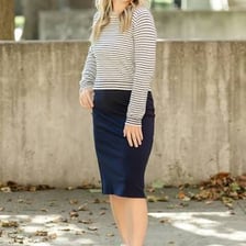 A person wearing a mid-calf midi skirt