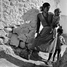A mother with her child in a family setting.
