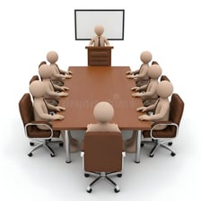 A meeting leader presiding over people seated around a conference table.