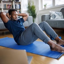 Person performing a crunch exercise to work the abdominal muscles