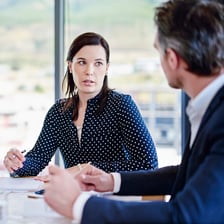 An employee speaking with a manager in an office.
