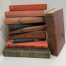 A large, thick hardcover book resting on a table.