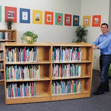 A librarian organizing books on library shelves.