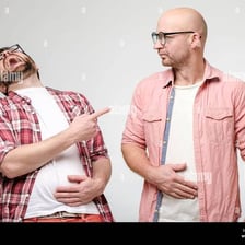 A person laughing loudly in response to a joke.