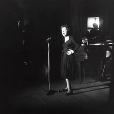 A photograph of French singer Edith Piaf performing