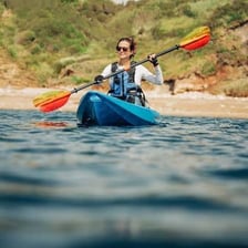 A kayaker paddling a kayak on a river