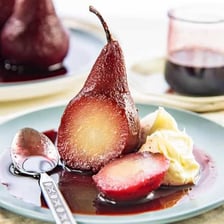 A pear poached and served as a dessert