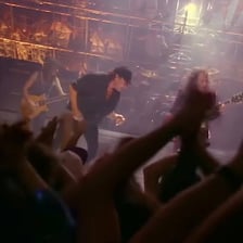 AC/DC performing onstage with guitars and concert lights