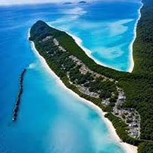 An aerial view of a coastline forming a broad curved bight.