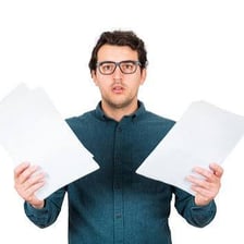 A person secretly looking through documents.