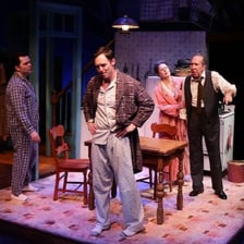 A stage production depicting Willy Loman from Death of a Salesman.