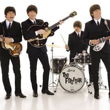 The Beatles performing together as the group known as the Fab Four.