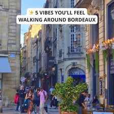 Two friends greeting each other in a French city.