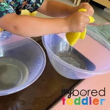 A hand gently dabbing a wet surface with a sponge.