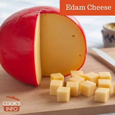 A round wheel of Edam cheese with its characteristic wax coating.