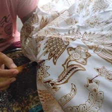 Wax being applied to fabric in a batik resist-dyeing process