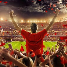 Fans cheering from stadium bleachers