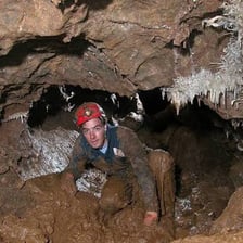 A person exploring an underground cave.