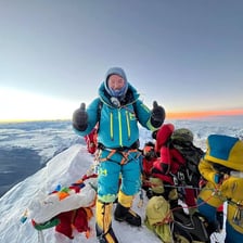 A Sherpa mountain guide carrying equipment in the Himalayas.