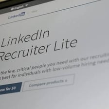 A laptop displaying an online employment listing.