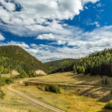 A scenic view of Taos, New Mexico, with mountains in the background.