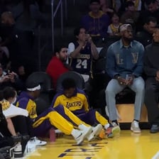 A sports player sitting on the bench during a game
