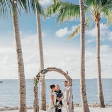 A newly married couple leaving together in a small wedding getaway scene.