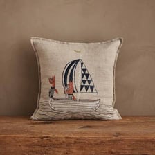 A soft pillow shown beside a small boat