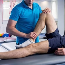 A person recovering from an injury during physical therapy