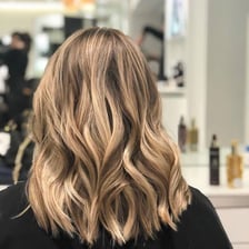 A person displaying a sleek, straight hairstyle.
