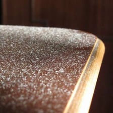 A visible layer of dust on a piece of furniture