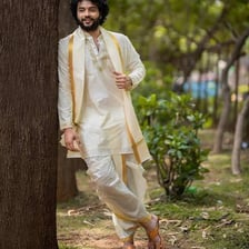Men wearing traditional dhotis wrapped around the waist and legs.