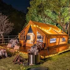 A tent set up at a forest campsite