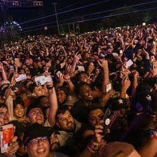A concert crowd celebrating a successful performance