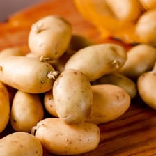 Several fresh potatoes, commonly called spuds