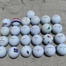 A golf ball resting on a tee on a golf course
