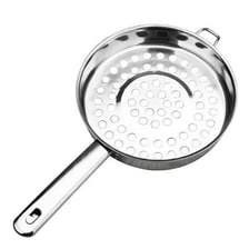 A perforated metal colander used for draining food.