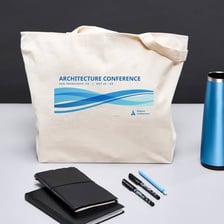 A promotional giveaway bag containing event merchandise