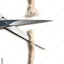 A rope being cut apart with scissors.