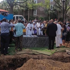 A burial taking place in a cemetery