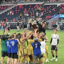A sports team celebrating a comfortable win.