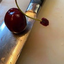 A small pile of detached cherry stems