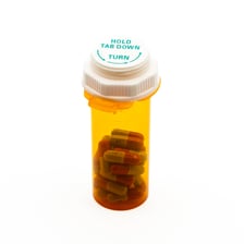 A prescription medication bottle in a pharmacy setting.
