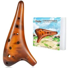 A ceramic ocarina with finger holes and a mouthpiece.