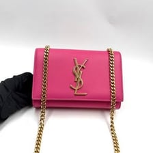 The YSL logo displayed on a luxury handbag