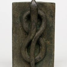An ancient Egyptian funerary object decorated with a serpent motif.